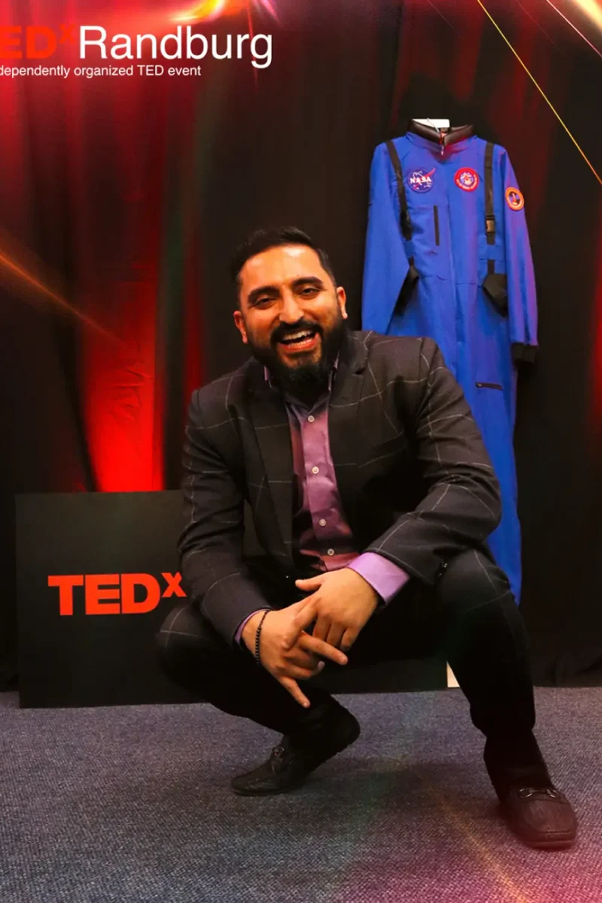 Dr. Shehz speaking on a TEDx stage